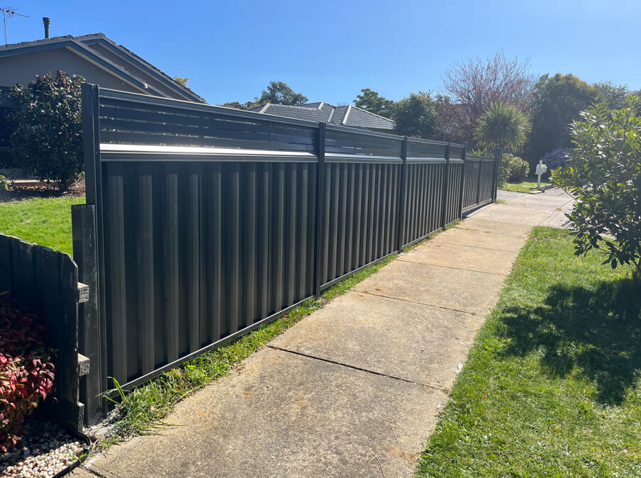 1.5m high Monument Colorbond front boundary fence with 300mm lattice extension and double driveway gates completed for added privacy and security in Narre Warren.