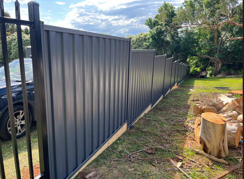 2m high Domain Colorbond privacy fence with timber sleepers completed for a shared boundary fence replacement between existing homes in Narre Warren South.