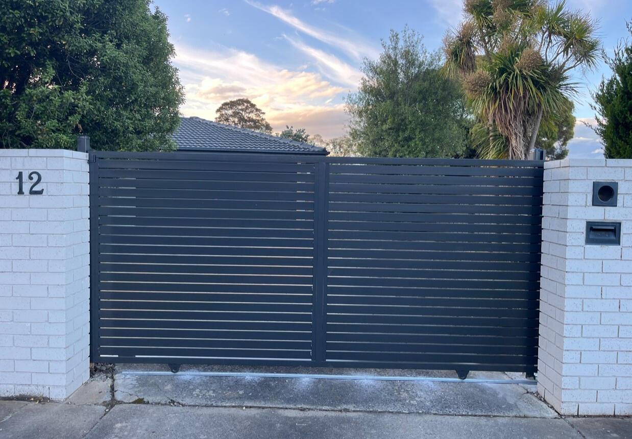 3m automated Monument aluminium slat sliding gate completed in Traralgon featuring remote-controlled access system for improved security, convenience and contemporary street appeal.