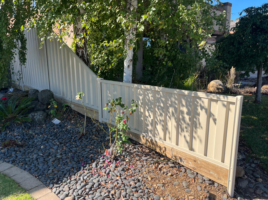 Paperbark Colorbond front fencing completed as a timber fence replacement for an existing property in Berwick, featuring stepped panels to suit the sloping site.