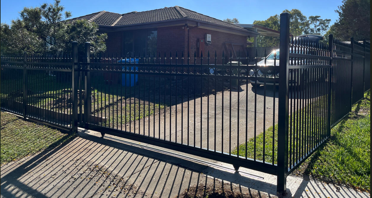 Premium 5m wide ring and spear sliding gate completed in Cranbourne North featuring seamless integration with matching front yard fencing for a secure and architectural entrance.