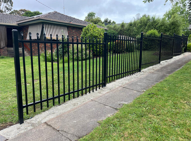 Black spear-top metal front fence installed to improve property security in Drouin. Decorative front garden fencing completed to create a more secure and defined property boundary while maintaining an open modern street presence.
