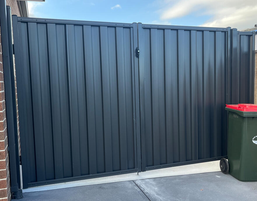 Heavy-duty Monument Colorbond double gates with reinforced welded frames completed for a repeat customer in Warragul, designed for secure driveway access and long-lasting performance.