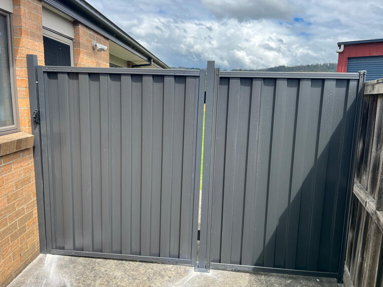 1.2m wide Monument Colorbond side access gate with matching 1m fence extension completed in Yarragon for improved backyard access and functionality.