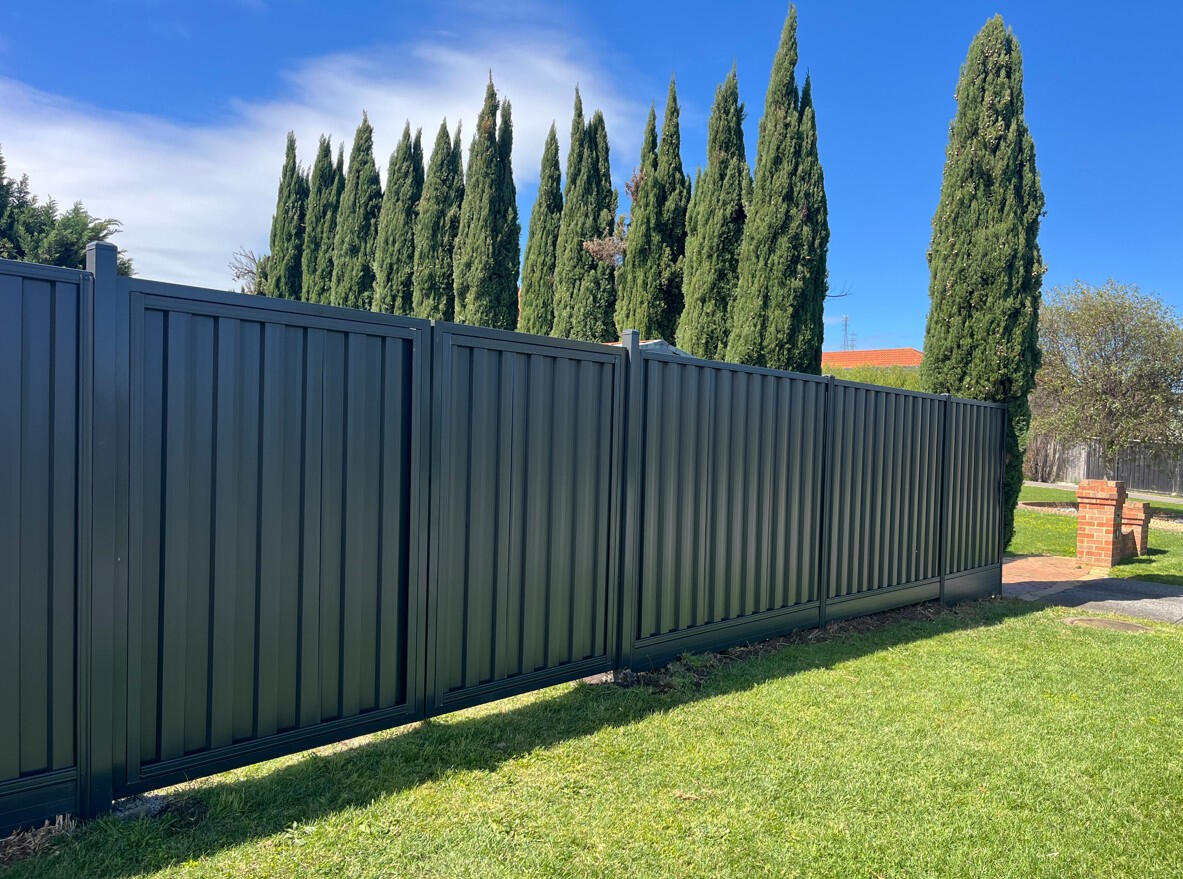 Custom Colorbond double driveway gates completed in Narre Warren North to provide secure rear property access with a matching modern fence design.