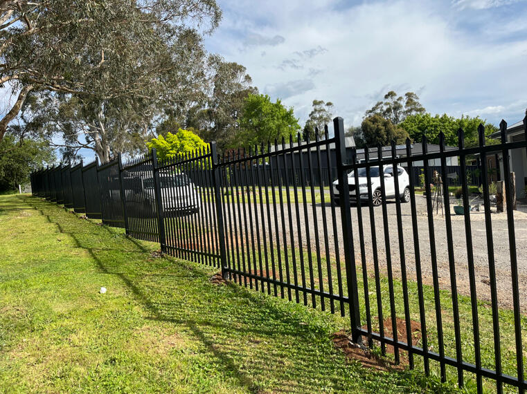 2.1m high black spear-top steel security fencing completed for a commercial factory in Seaford, designed for improved perimeter security and industrial property protection.
