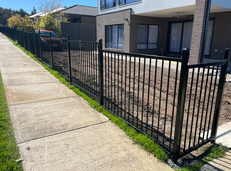 1.2m high stepped flat top metal fencing completed in Pakenham to define the property boundary beside a public footpath while enhancing street appeal and safety.